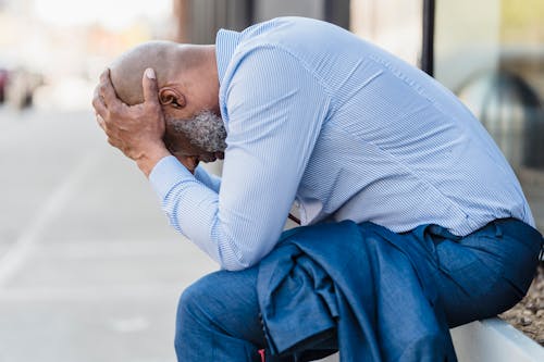 Free Man Touching his Head Stock Photo