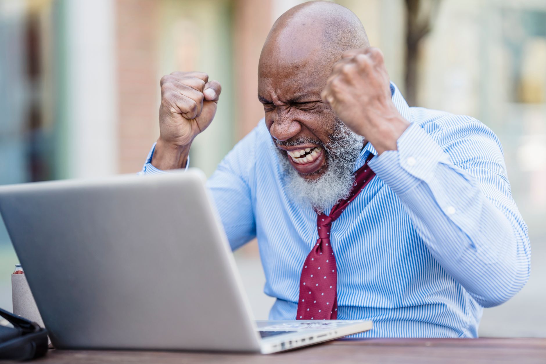 A frustrated professional looking at a laptop after repeated request errors.