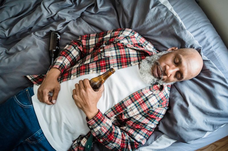 Drunk man sleeping with beer bottles