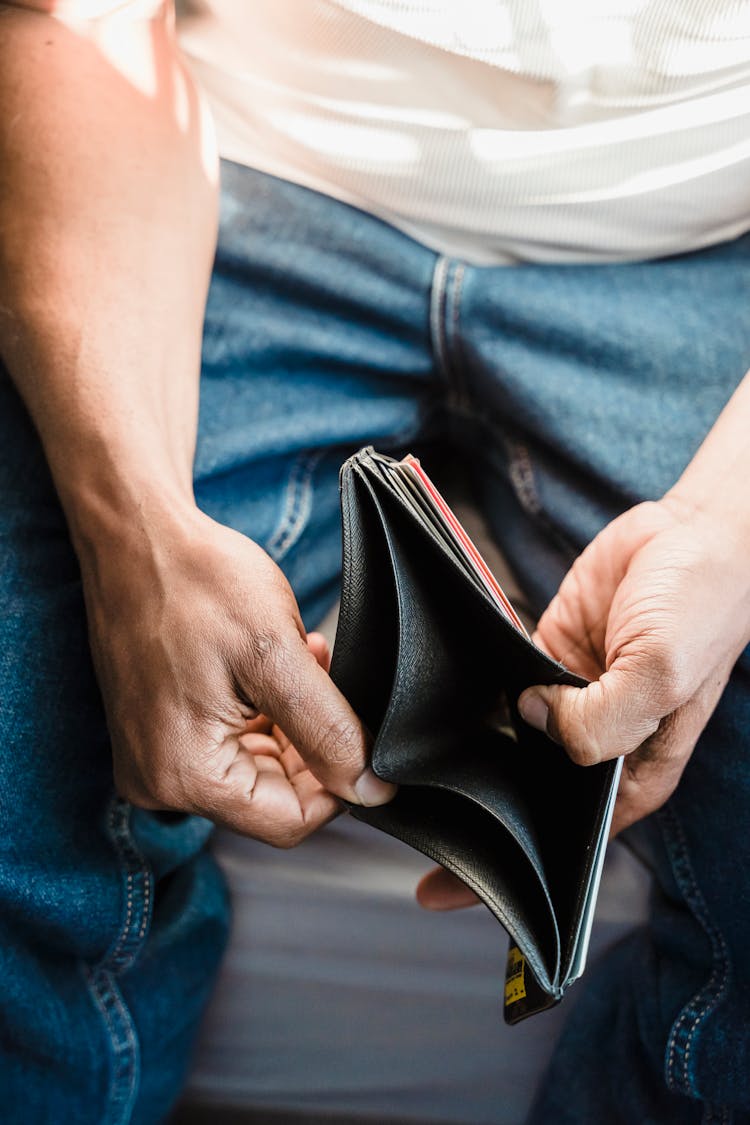 A Person Holding A Wallet