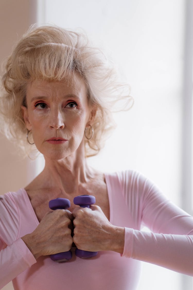 An Elderly Woman Holding Dumbbells