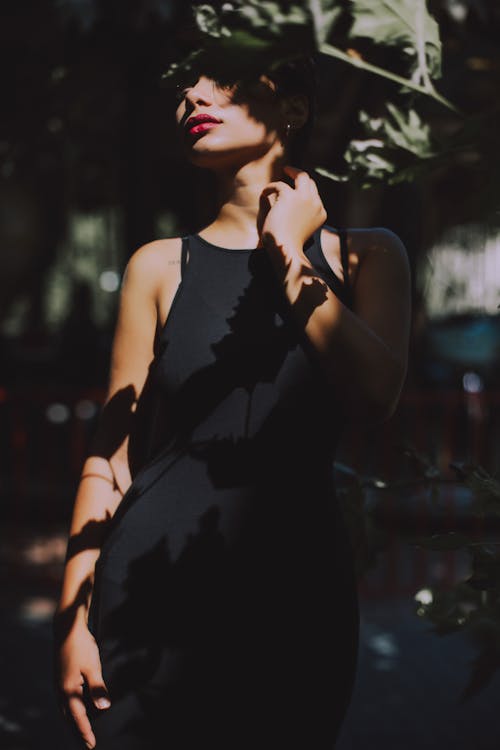 Woman Wearing Black Sleeveless Top Dress Under the Tree