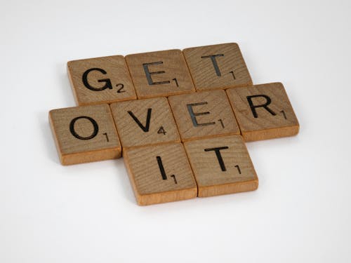 Brown Wooden Scrabble Blocks on White Surface