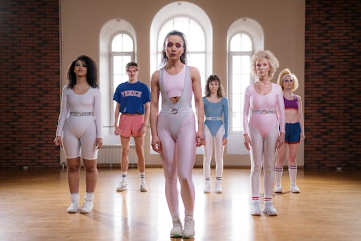 A diverse group of adults in retro aerobics outfits during a class session indoors.