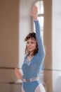 A Woman in Blue Leotard Exercising