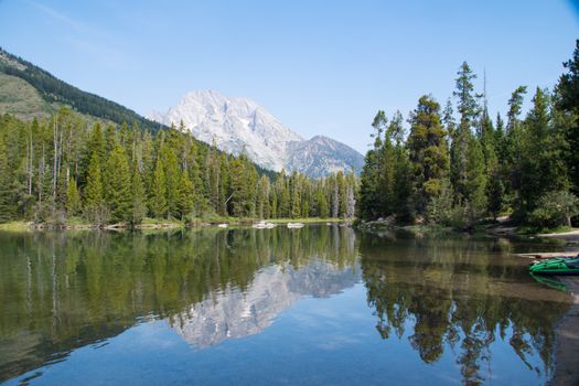 Tranquil lake with mountain reflections in Grand Teton National Park, WY, USA.