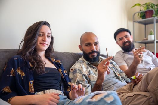 Casual gathering of friends smiling and relaxing indoors. Capture of togetherness with a laid-back vibe.