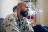 A Man Exhaling Smoke from Mouth
