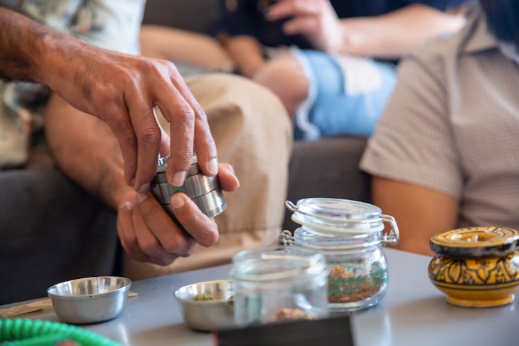 Person Holding Aluminum Round Container