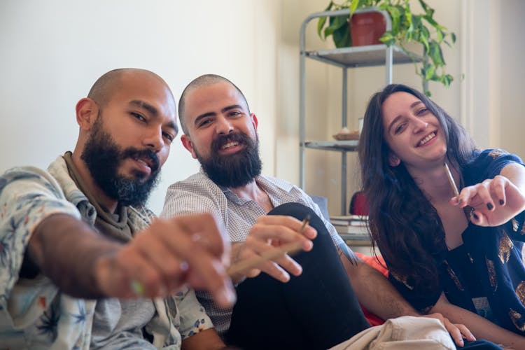 A Group Of People Smoking Cannabis Cigarettes