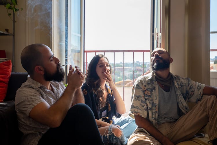 Group Of People Smoking Beside The Balcony