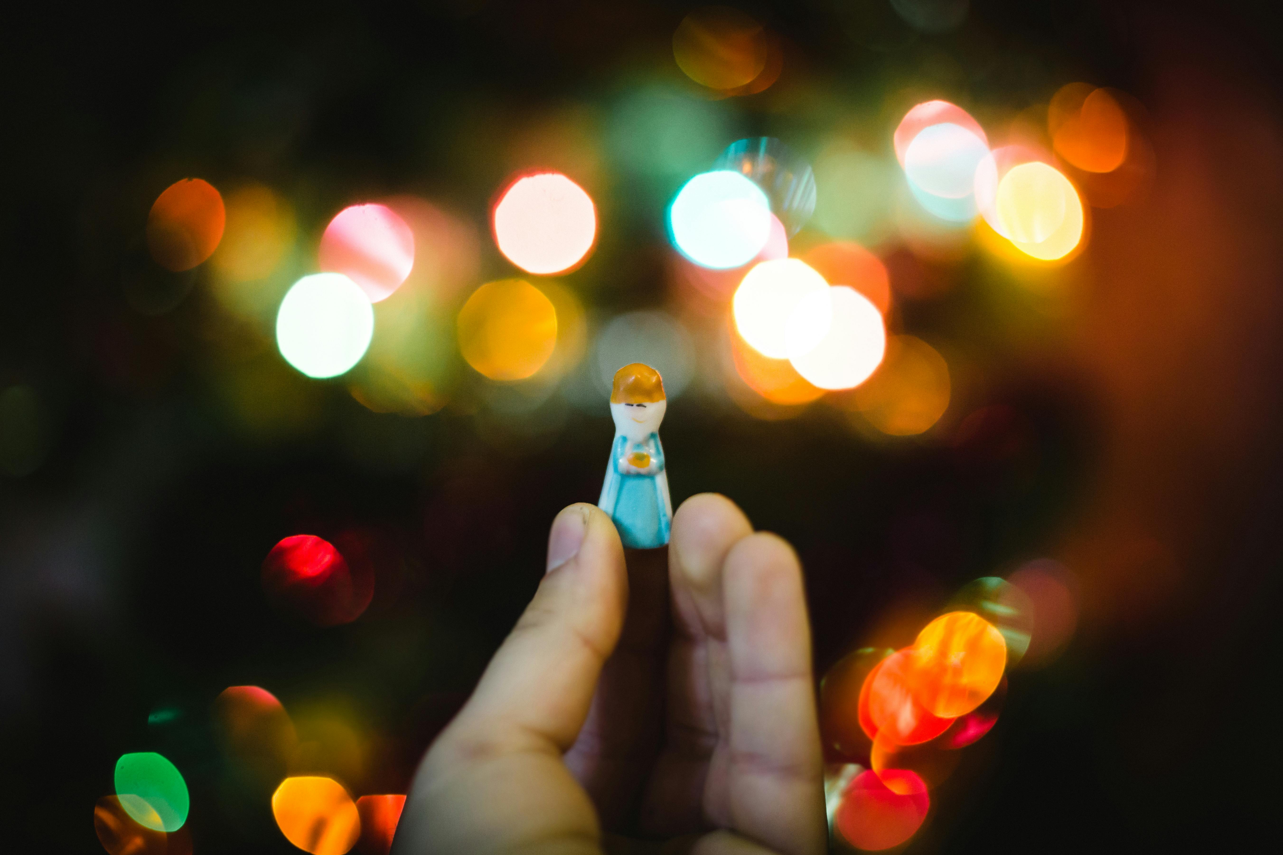 person holding woman wearing dress plastic toy