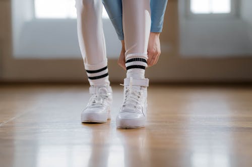 A Person Wearing White and Black Socks and White Shoes