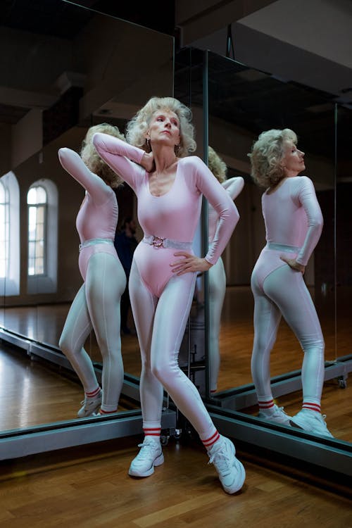 Senior Woman Posing in Pink Body Suit Leotard and Leggings on a