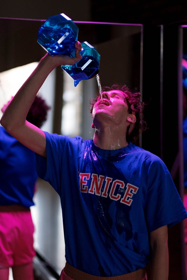 Man In Blue Shirt Drinking Water