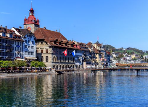 Free Charming cityscape of Lucerne, Switzerland, showcasing historic buildings and waterfront reflections. Stock Photo