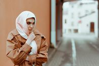 A Scared Woman Wearing a Coat and a Headscarf