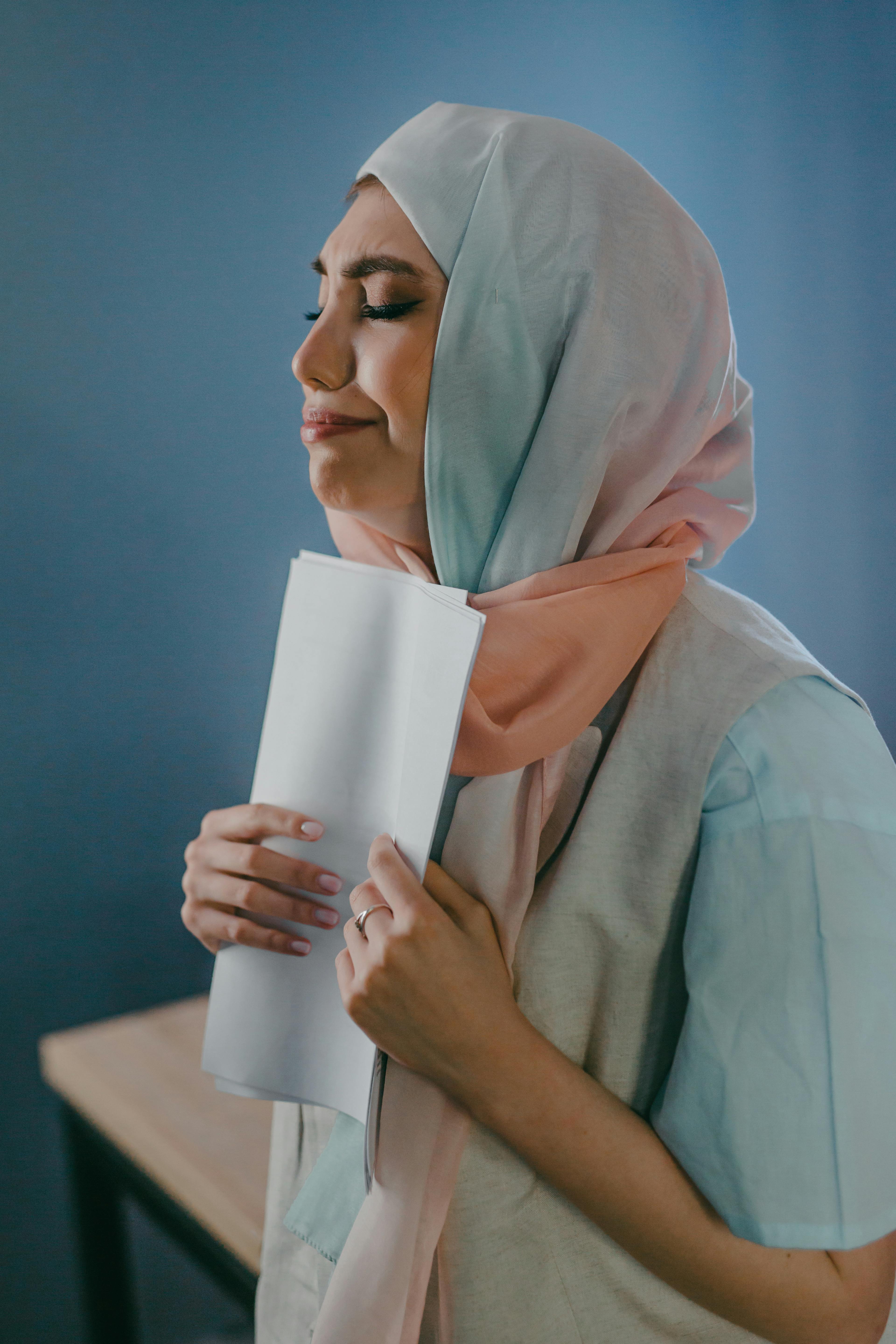 a scared woman holding papers