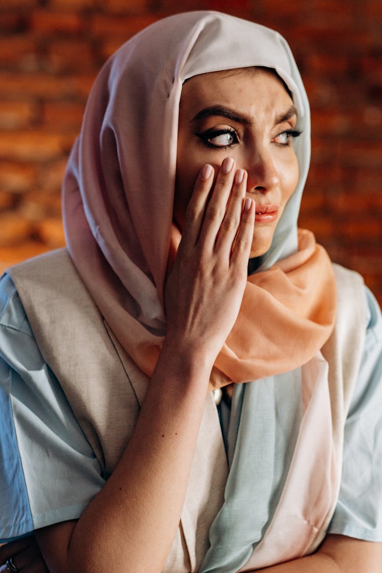 A Woman In A Hijab Crying 