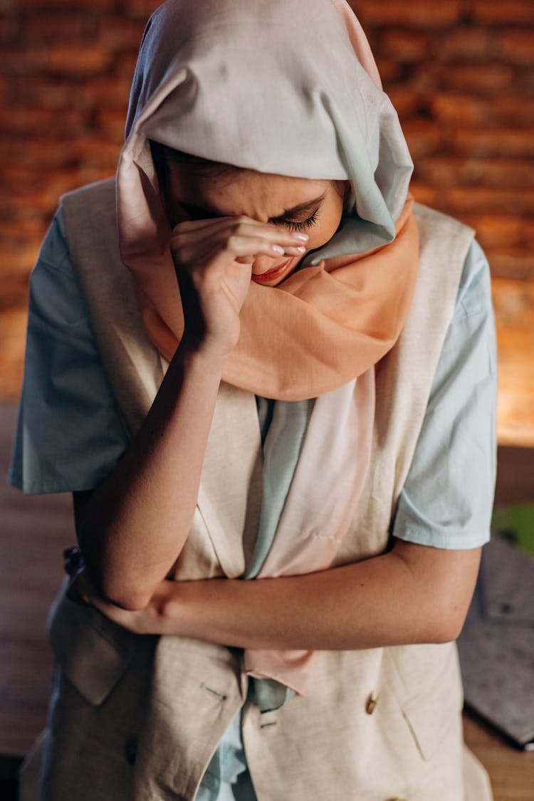 
A Woman In A Hijab Crying