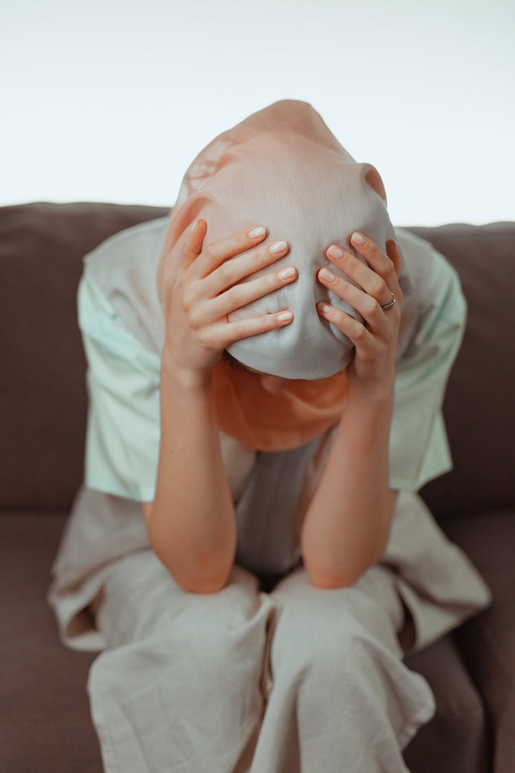 A Woman Holding Her Head