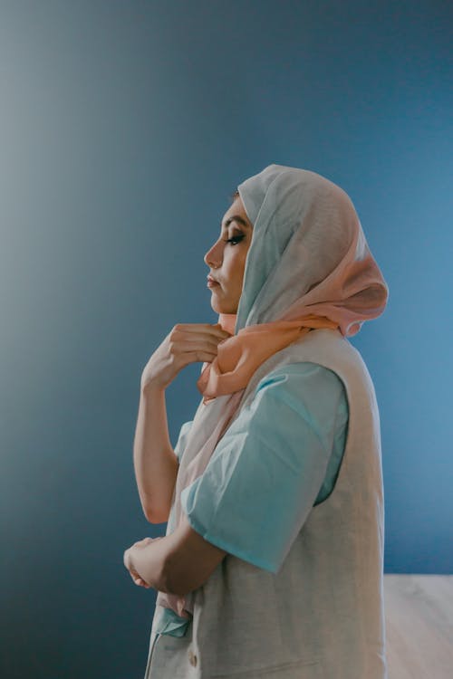 Woman Wearing Hijab Standing Near Blue Wall