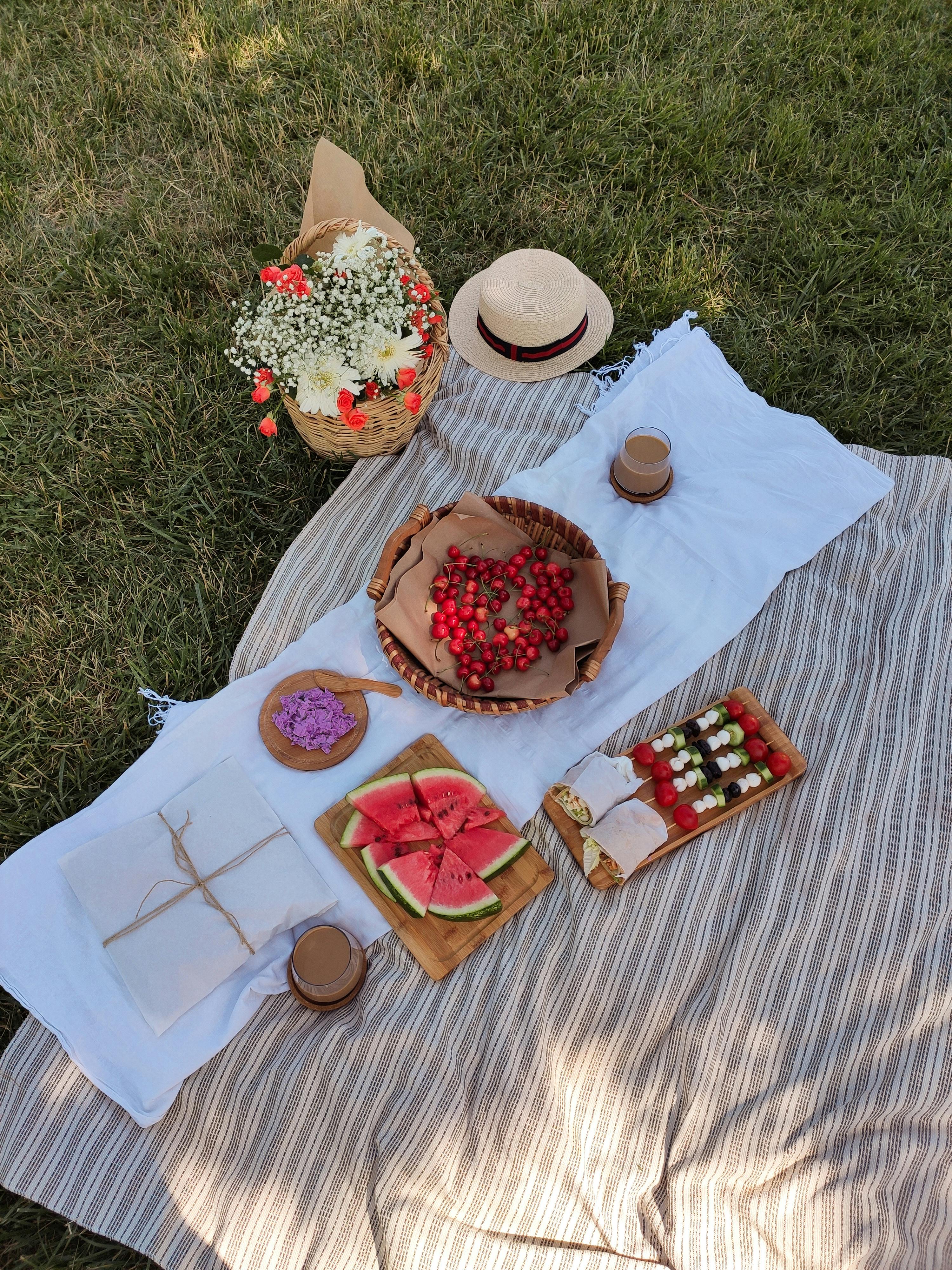 foods over a picnic blanket