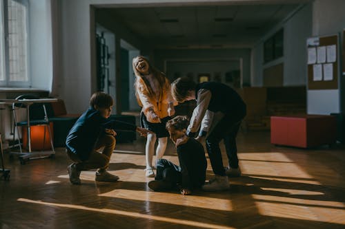 A Kid Getting Bullies by Classmates in School