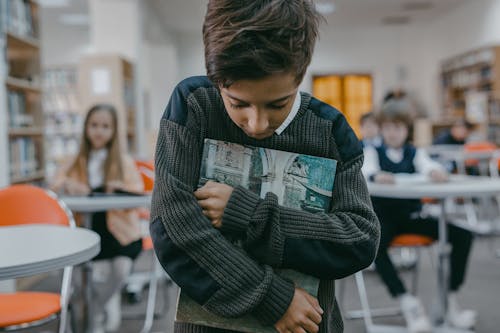 A Boy in Gray Sweater Getting Bullied