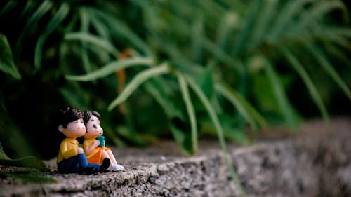 Free Plastic Figurines on a Concrete Surface Stock Photo