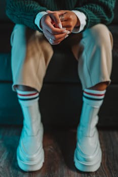 Person in White Pants and Blue Gloves