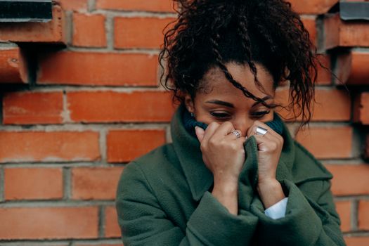 Woman in Green Sweater Covering Her Face With Her Hand