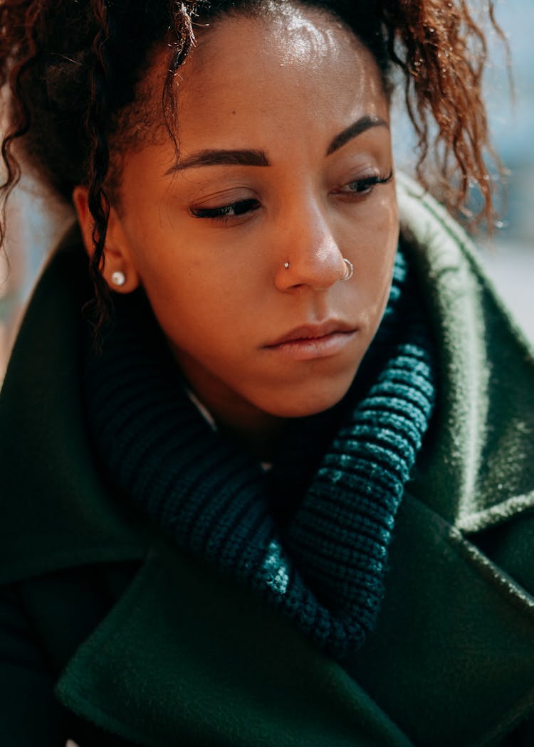 A Sad Woman In Winter Clothing Looking Afar