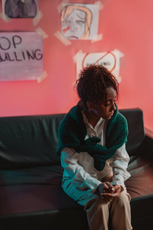 A Woman Sitting on Black Couch