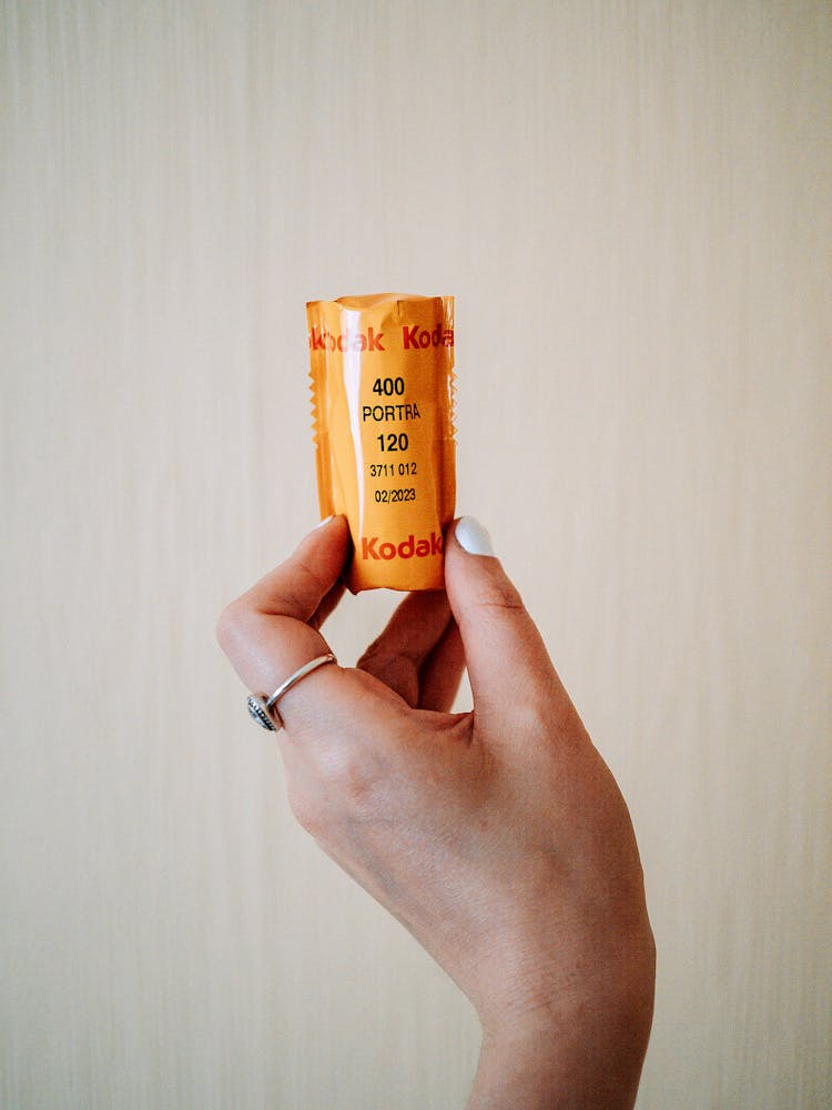 Person Holding Yellow Plastic Tube 