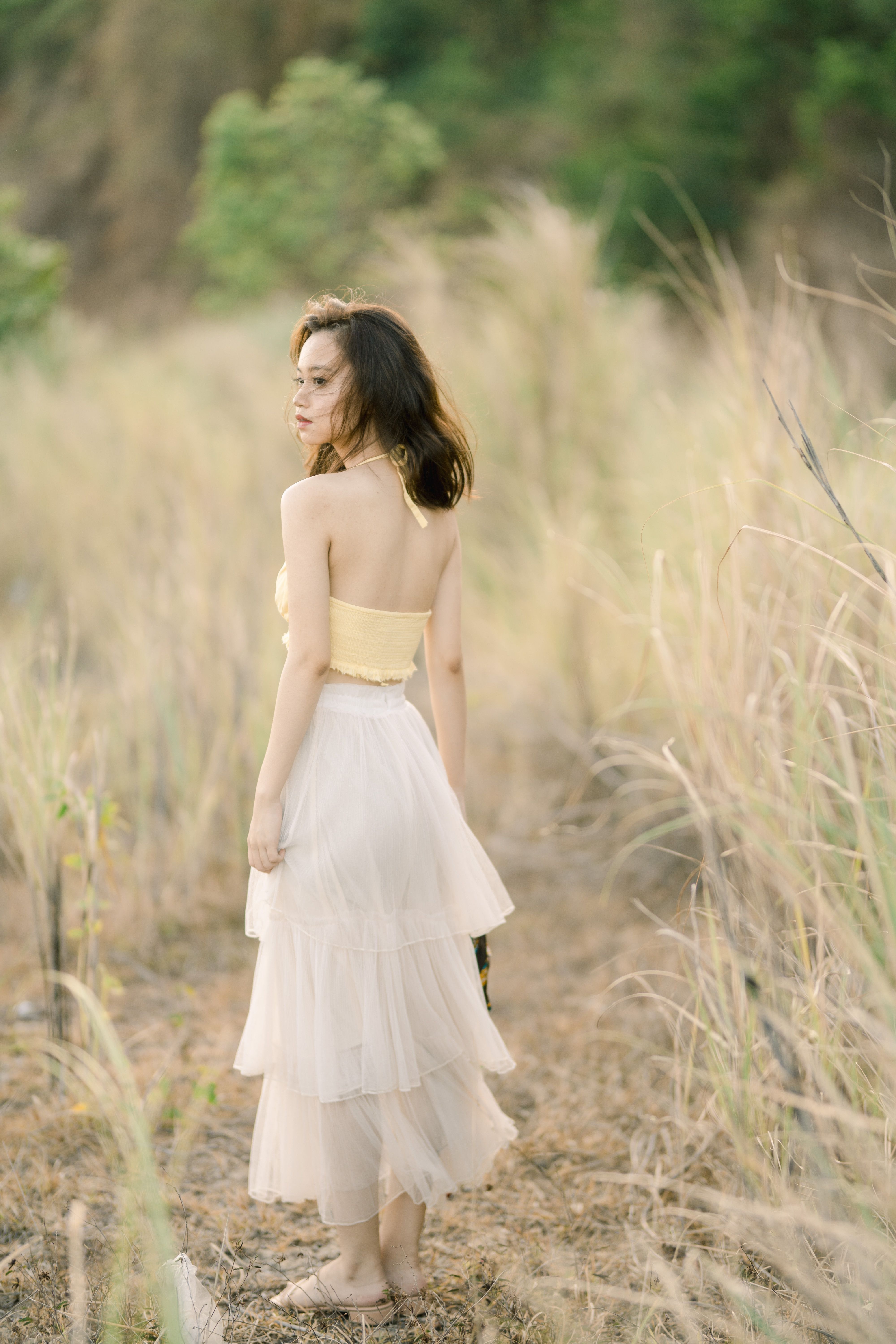 Girl in Yellow Tube Top and White Skirt Standing on Grass Field · Free ...