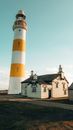 Lighthouse Beside a House