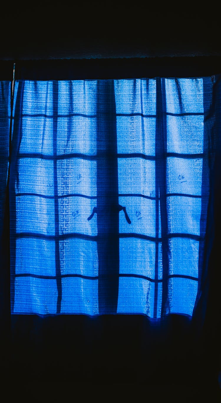 Blue Curtain Hanging On The Window