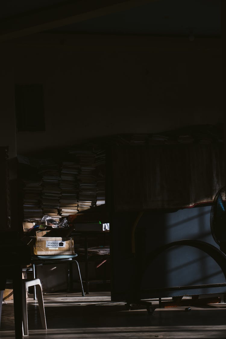 Stacks Of Documents And Books In A Dark Archive Room