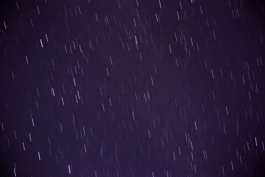Long exposure capturing vibrant star trails creating a dynamic night sky display.
