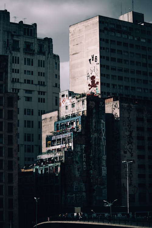 Tall buildings with damaged painted walls