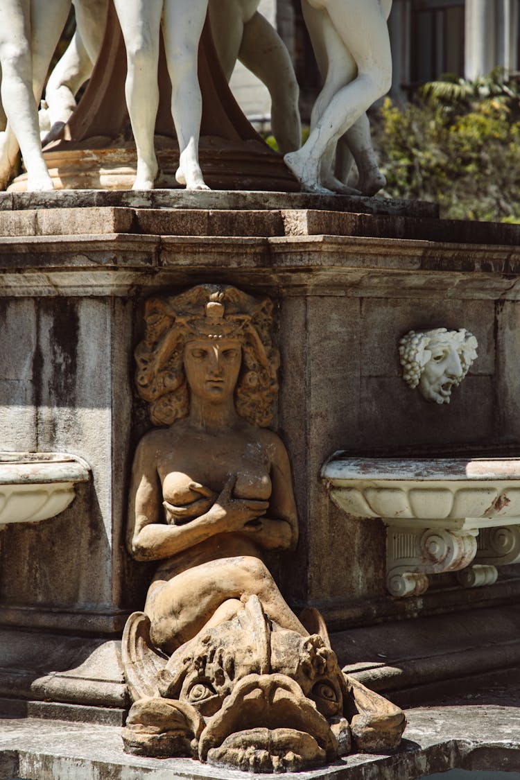 Sculpture Of Woman Under Plinth Of Monument