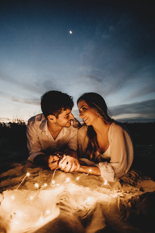 Romantic couple holding hands in evening