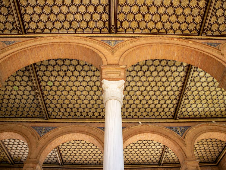 
A Pillar Supporting A Golden Ceiling