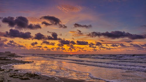 Sea Waves Crashing on Shore During Sunset