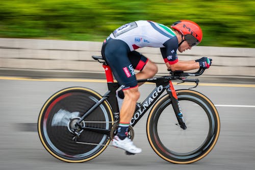 A Man Cycling on the Road 