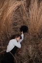 A Woman Lying Down on Dry Grass