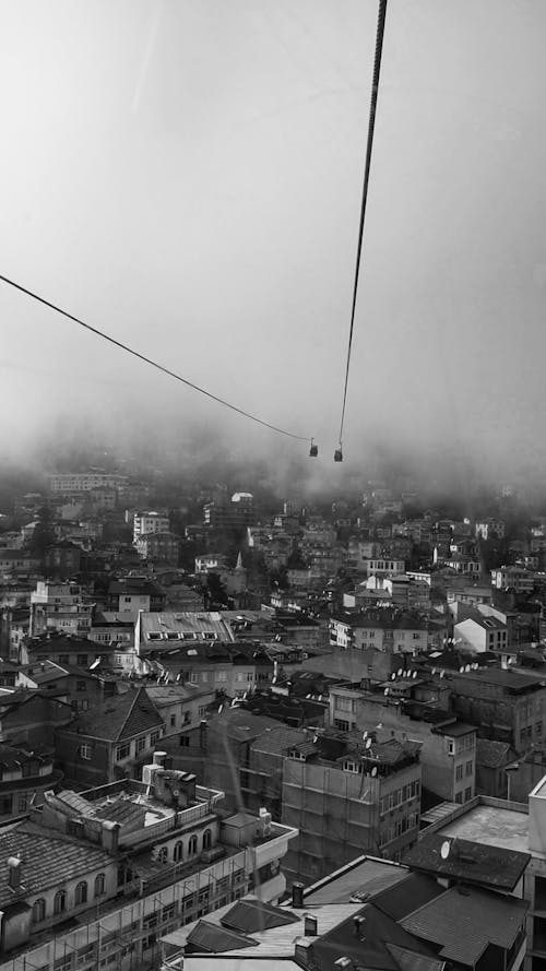 Free A Grayscale of Cable Car Lines over a City Stock Photo