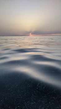 Tranquil sunset view over the sea in Algeria, capturing the calming water surface and vibrant sky.