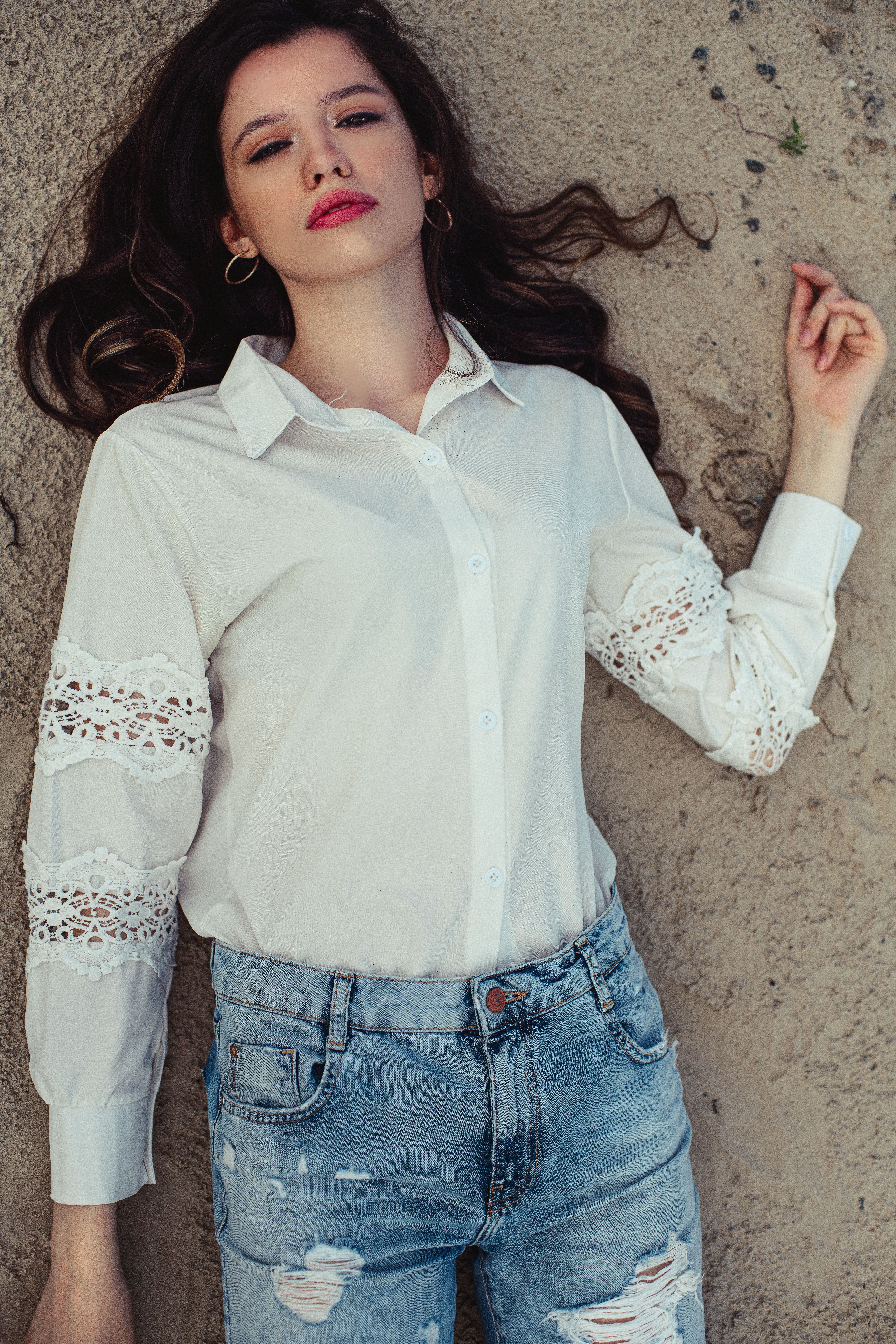 A Woman in White Long Sleeves Lying on a White Textile · Free Stock Photo